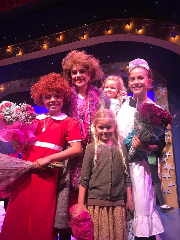 Cast members of Annie in costume