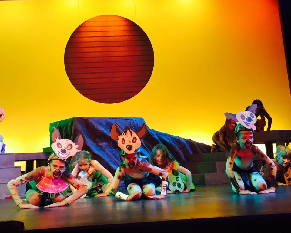 A Lion King Jr. scene under a red sun