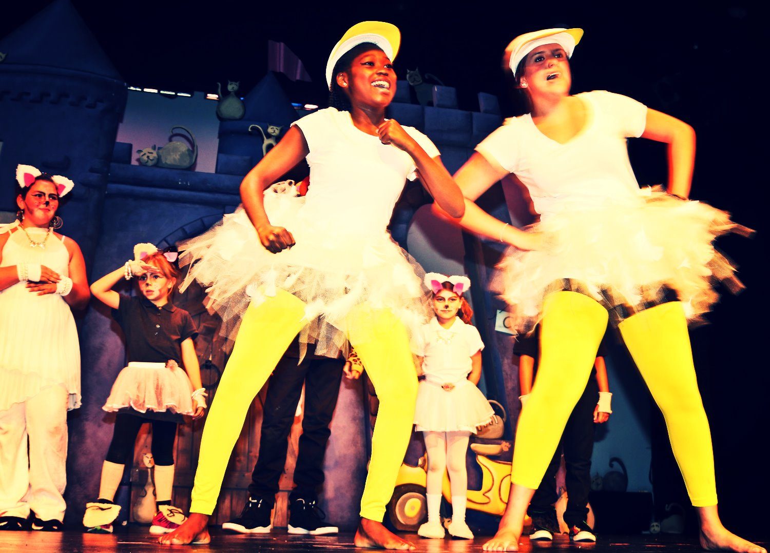 Dancers in white tutus and yellow tights