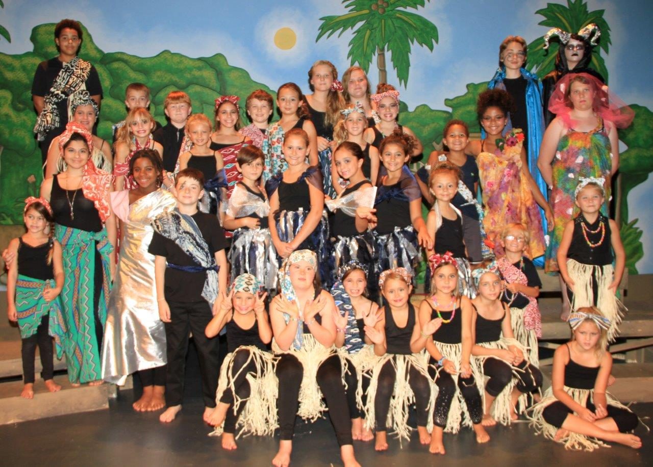 A large group of campers in costume on stage