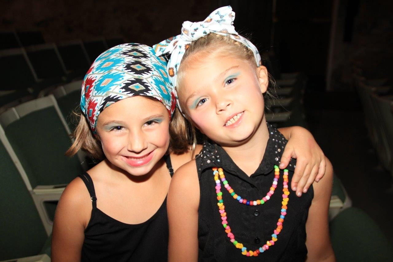 Two campers smiling in headscarves