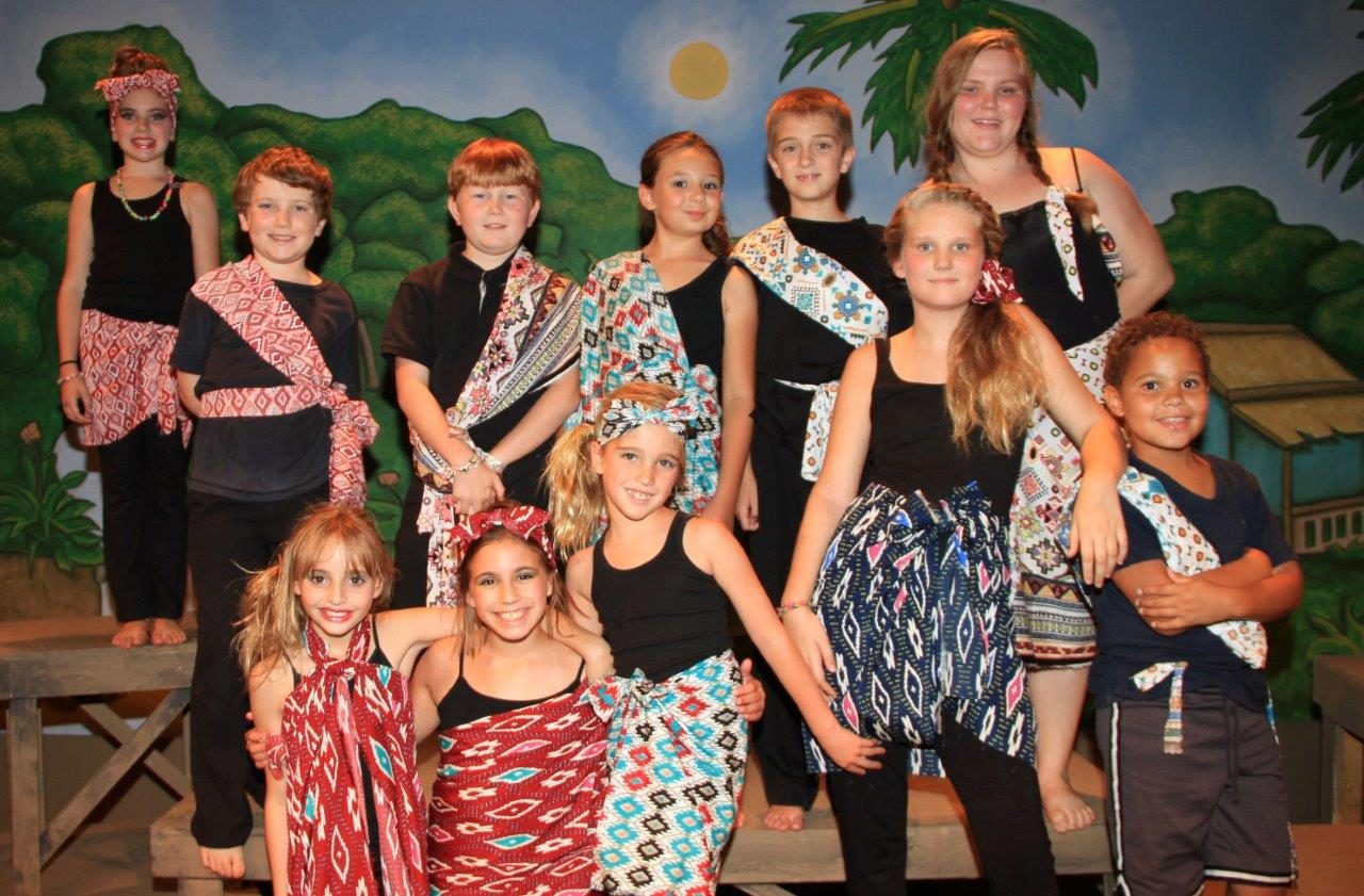A cast photo in island costumes