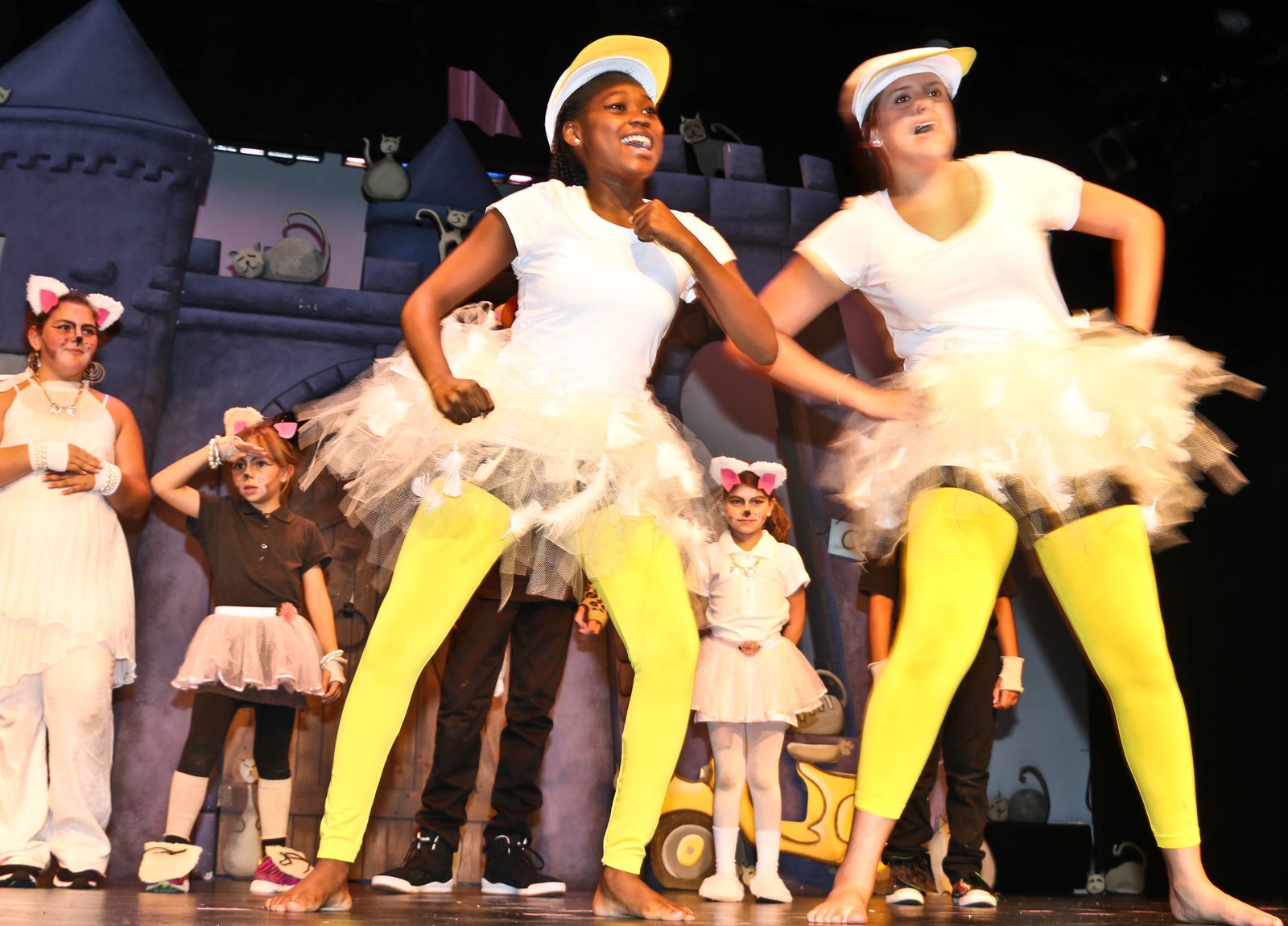 Dancers in white tutus and yellow tights