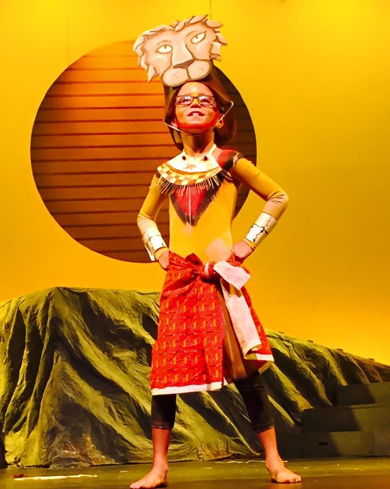 A performer in a Lion King Jr. costume