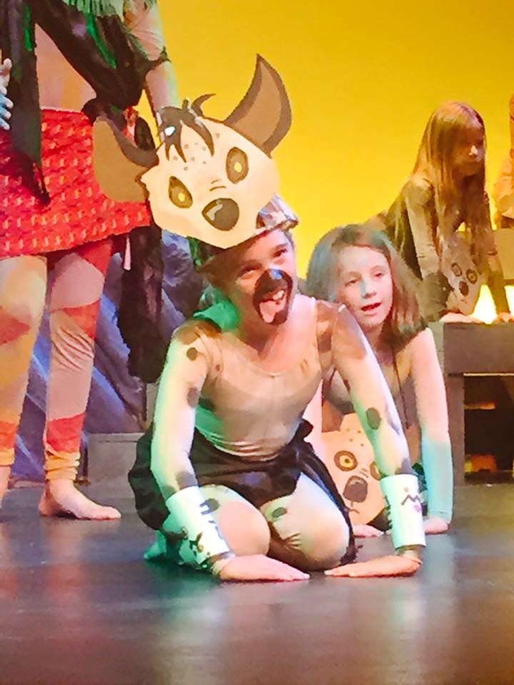 A Lion King Jr. performer in a hyena mask