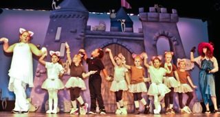 Dancers in front of a castle set