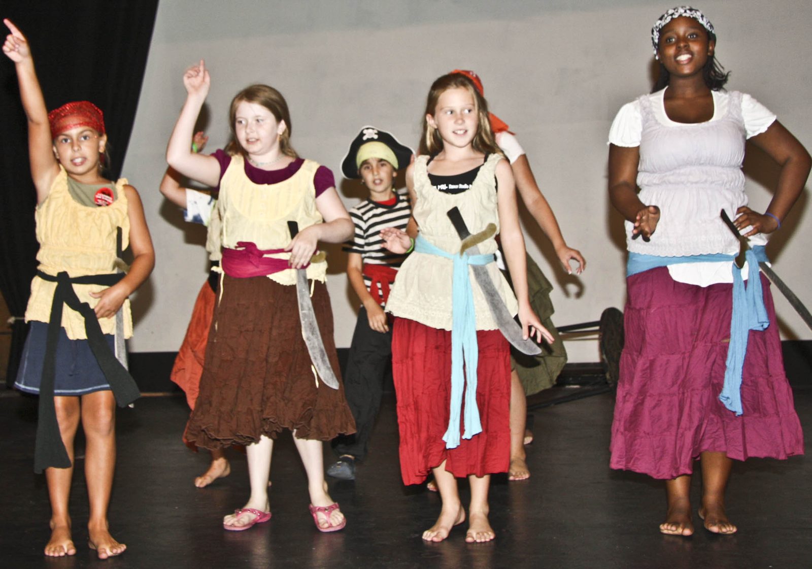 Campers in pirate costumes performing