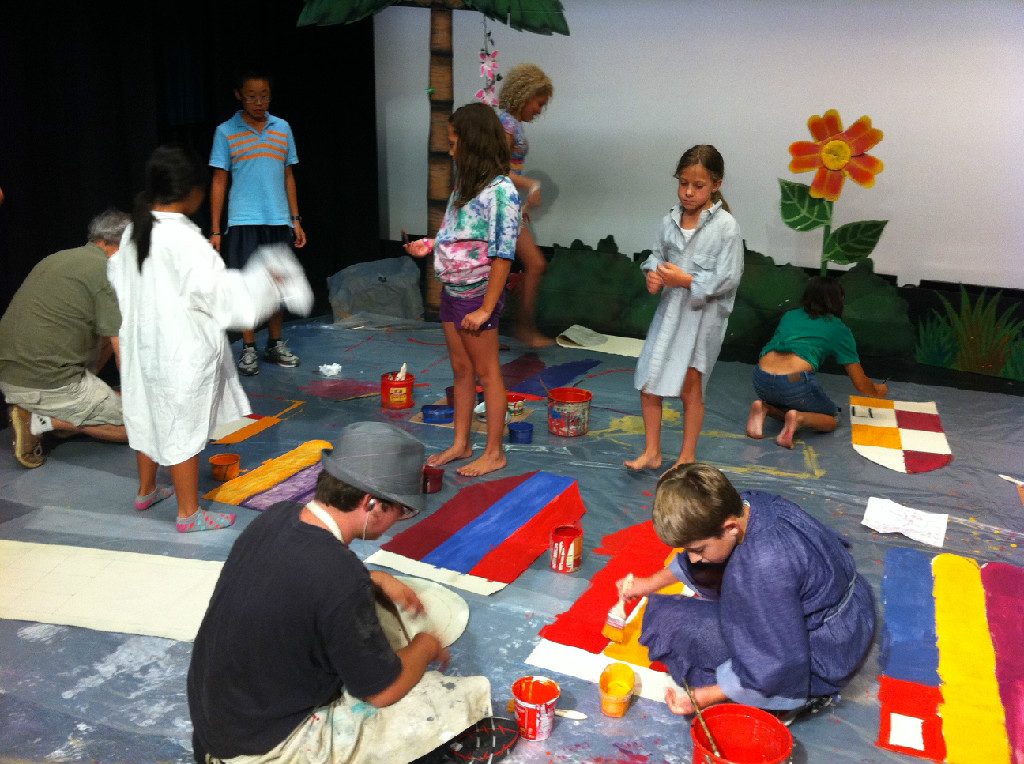 Campers painting a set