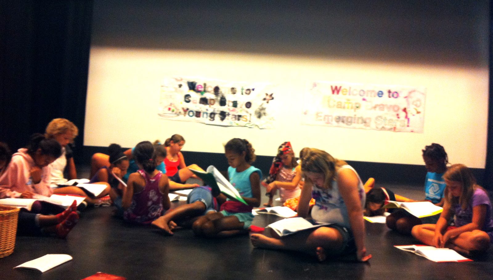 Campers reading their scripts on the floor