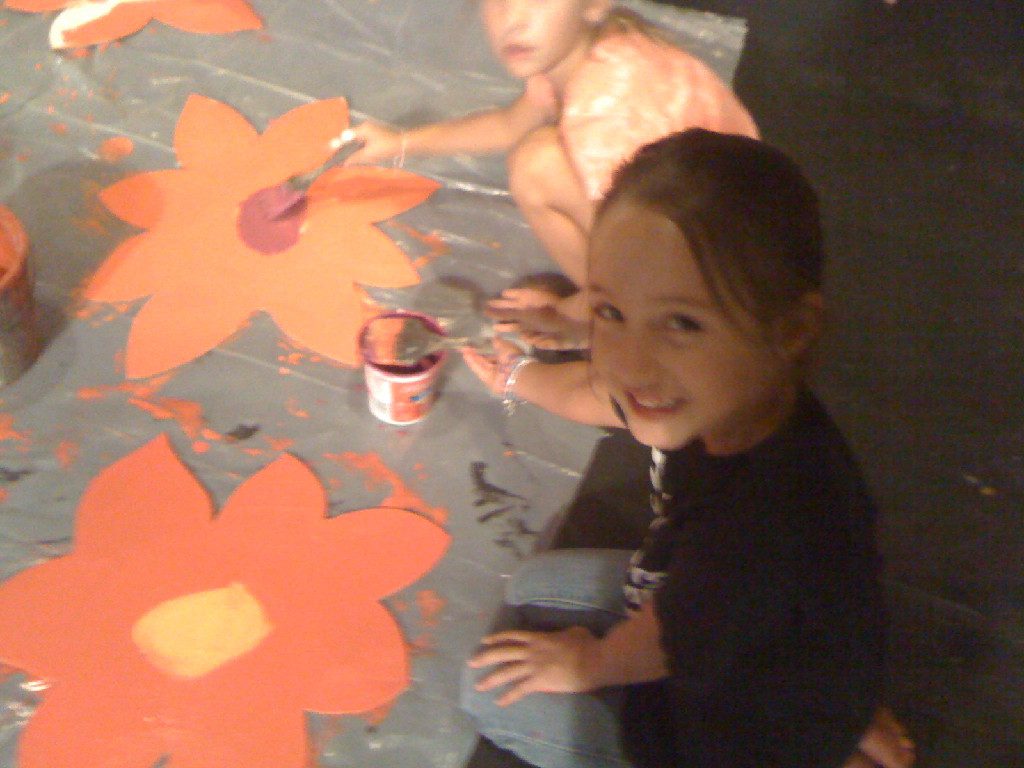 A camper painting flowers for the set